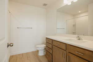 Full bathroom featuring vanity, light wood finished floors, a shower, and recessed lighting