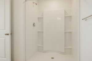 Full bathroom featuring a shower stall