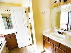 Full bathroom with a bath, vanity, and a shower with shower door