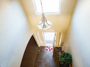 Foyer featuring dark stone finish flooring
