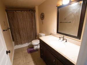 Full bathroom featuring vanity, shower / tub combo, and light tile patterned floors
