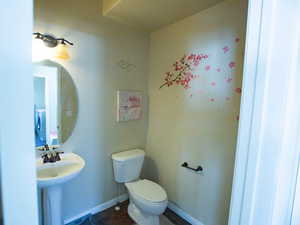 Bathroom featuring toilet and baseboards