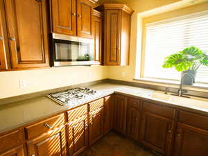 Kitchen featuring stainless steel appliances and wood finish cabinetry