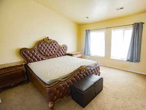 Bedroom featuring carpet and baseboards