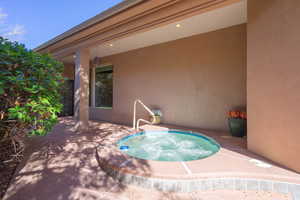 View of pool with an in-ground hot tub and patio surround