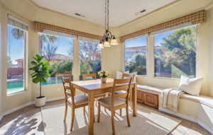 Virtually Staged Dining area featuring baseboards and light tile patterned flooring