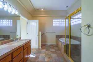 Bathroom with a bath, vanity, and a stall shower