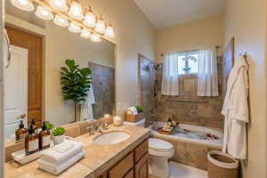 Bathroom featuring vanity and tiled shower / bath combo