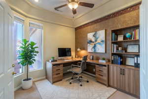 Office with a ceiling fan and light colored carpet