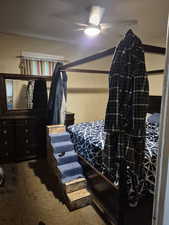 Bedroom with a ceiling fan and carpet flooring