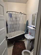 Bathroom with shower / tub combo and toilet