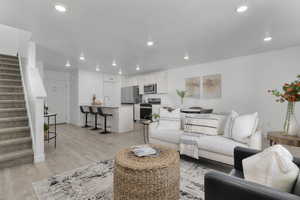 Living room featuring light wood-style floors and recessed lighting