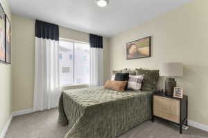 Bedroom with carpet and a textured ceiling
