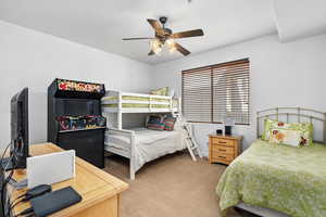 Bedroom featuring light colored carpet and ceiling fan
