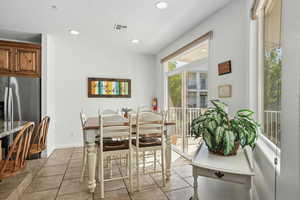 Dining area featuring recessed lighting and light tile patterned floors