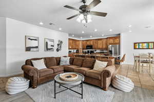 Living area with ceiling fan, recessed lighting, and light wood-type flooring