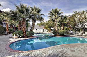 Community pool with a patio