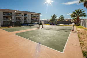 View of tennis court with community basketball court