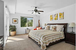 Bedroom featuring light carpet and a ceiling fan