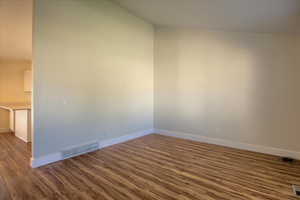 Empty room with dark wood-type flooring