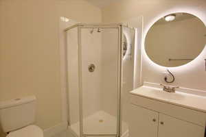 Full bath with vanity and a shower stall