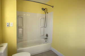 Bathroom with tub / shower combination and tile patterned floors