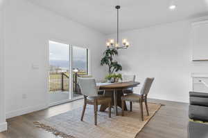 Dining space featuring light wood-style floors and a chandelier
