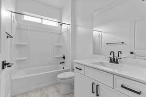 Bathroom with vanity and washtub / shower combination
