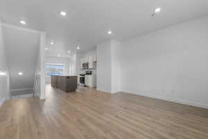 Unfurnished living room with light wood-style floors and recessed lighting