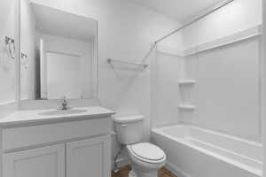 Bathroom with vanity, shower / bath combination, and dark wood-style floors
