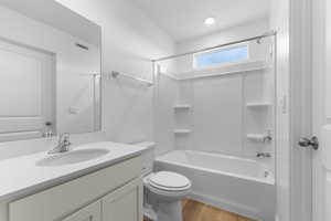 Bathroom with vanity, shower / bathtub combination, and light wood-type flooring