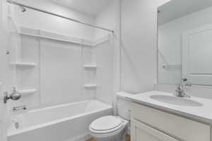 Bathroom featuring vanity and  shower combination