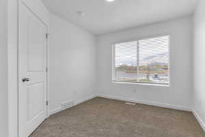 Unfurnished bedroom with baseboards and carpet flooring