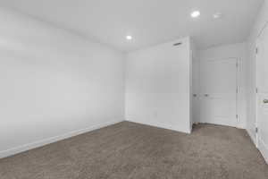 Unfurnished room featuring carpet and recessed lighting