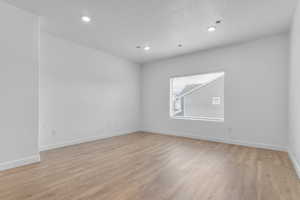 Unfurnished room featuring light wood-type flooring and recessed lighting