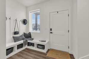 Mudroom with dark wood finished floors