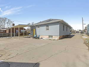 Rear view of property with driveway