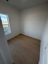 Unfurnished room with light wood-style floors and baseboards
