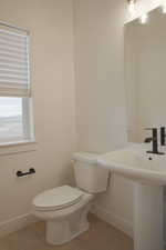 Bathroom with toilet and baseboards