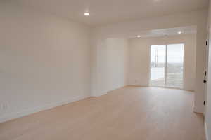 Spare room with light wood finished floors and recessed lighting