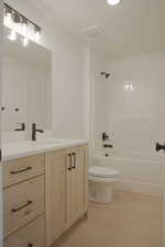 Bathroom with vanity and bathtub / shower combination