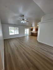 Unfurnished living room with light wood-style floors and a ceiling fan