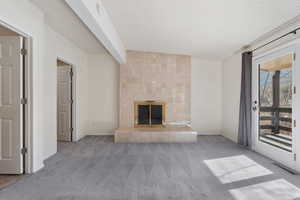 Primary Bedroom with woodburning fireplace and door to covered deck.