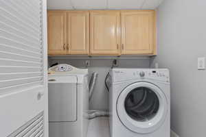 Laundry area with cabinet space and washer and dryer