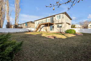 Rear view of property with a fenced backyard, stairs, and a wooden deck