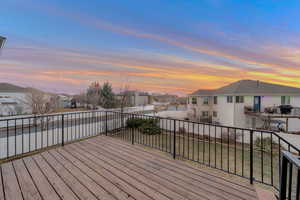 Wooden deck with a residential view and grilling area