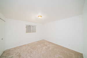 Unfurnished bedroom featuring a closet and carpet flooring