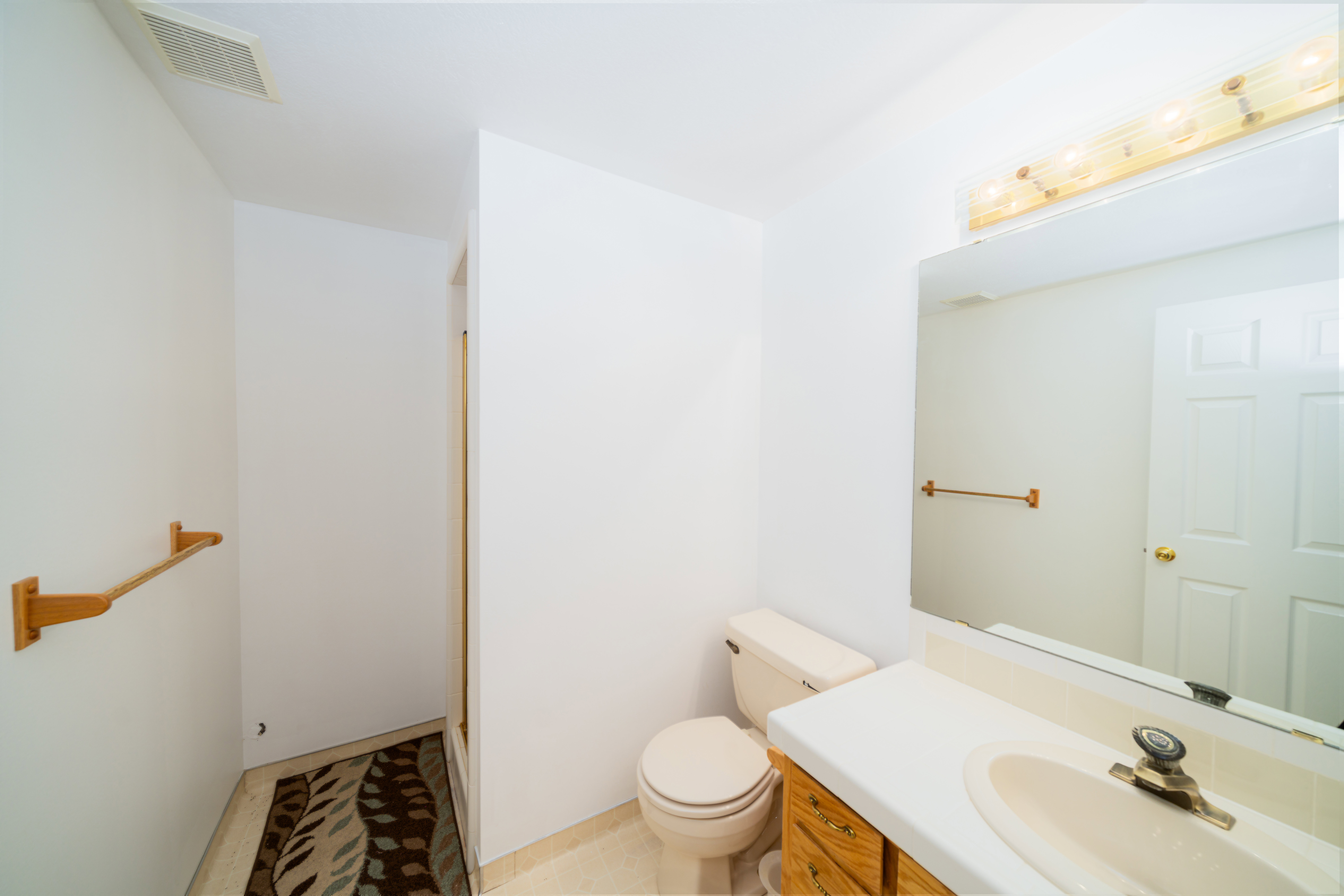 Bathroom with vanity and a shower with door