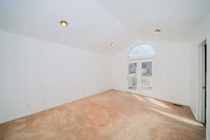 Carpeted spare room with baseboards