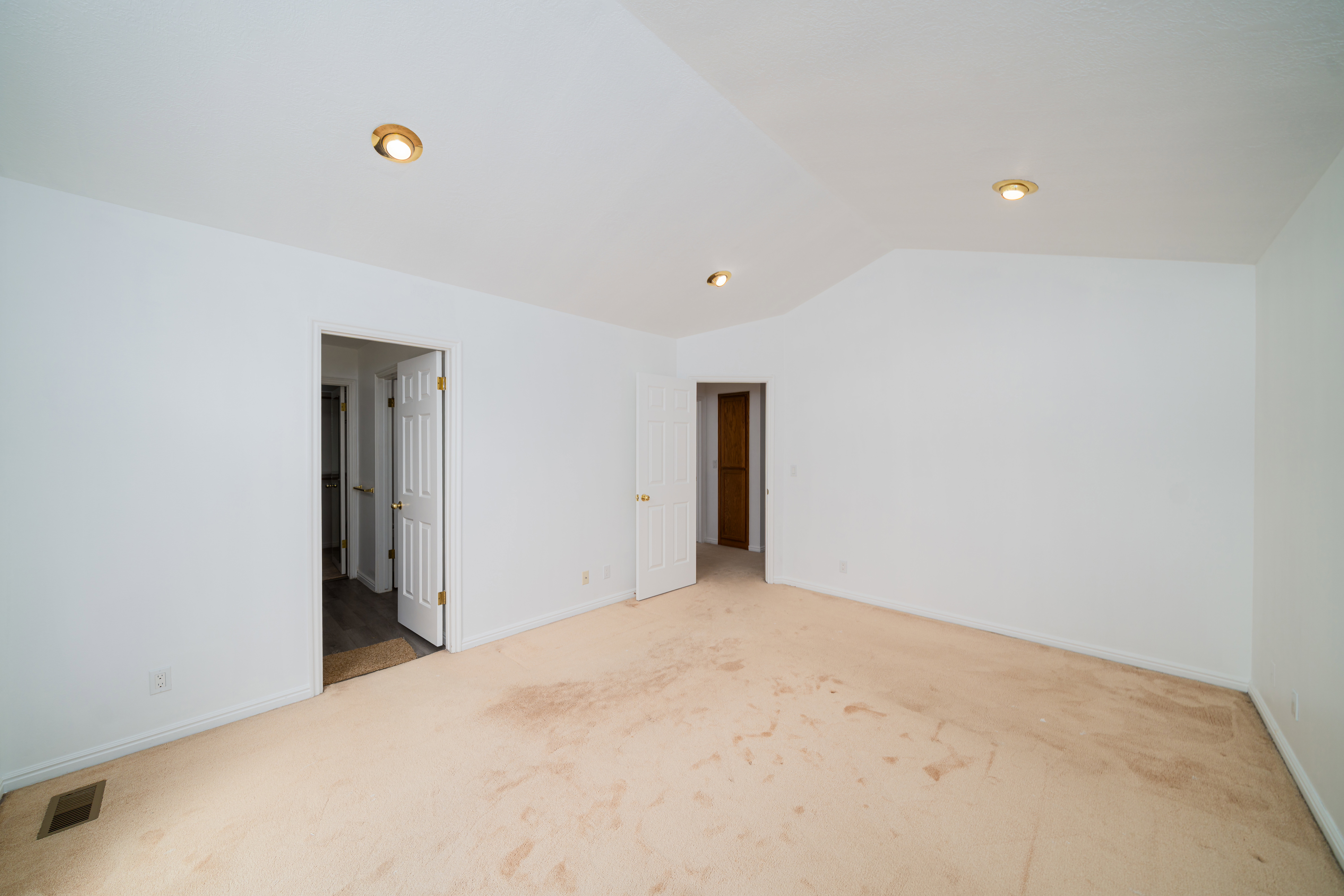 Unfurnished bedroom with carpet and ensuite bathroom